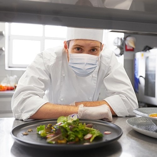 Restaurant Chef in Uniform Wearing a Face Mask and Latex Gloves